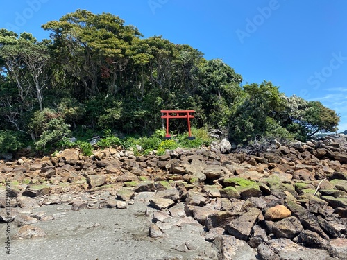 A beautiful shinto shrine along the scenic beaches along the coast of the Wakayama prefecture beside the Hashiguiiwa Rocks on a beautiful sunny day in Japan photo