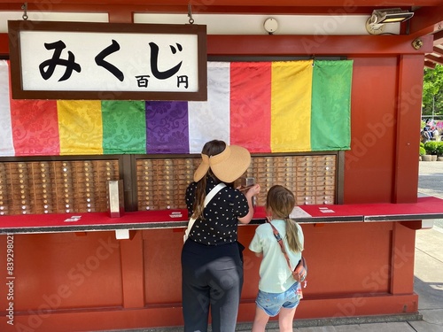 Photography A mother and daughter getting their omikuji, or written fortunes, as the Senso-j
