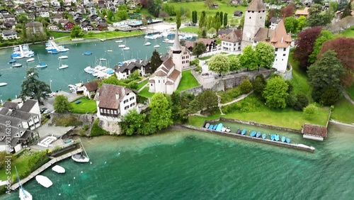 by Spiez Castle ( by Lake Thun (Thunersee), a lake in the Bernese Alps, Spiez Marina , Castle Church in Spiez , Panoramic Train Route (Panorama Express) drone, aerial photo