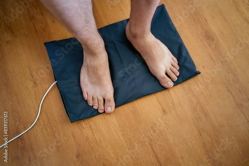  man put his feet on the grounding wedge, self-soothing, relaxation photo