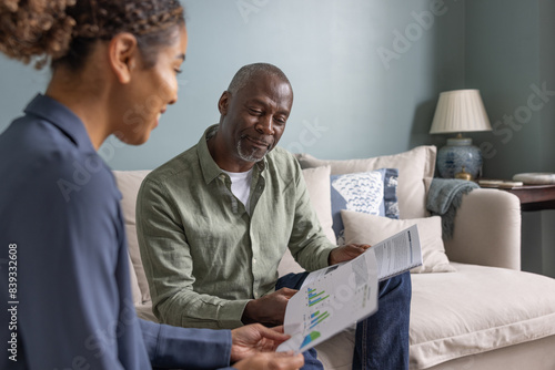 Senior male meeting with a financial advisor in his home photo