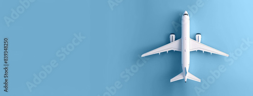 Airplane flying overhead on a blue background, concept of travel