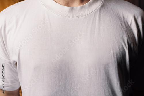 Close-up of a white shirt on a male chest with ample copy space, highlighting the fabric and clean, classic look