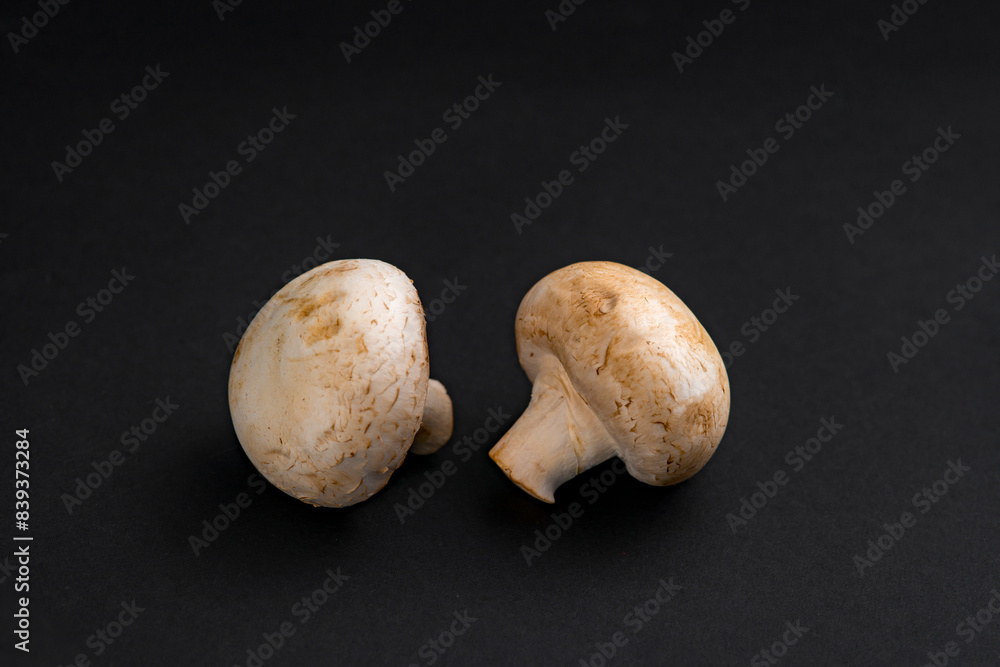fresh champignons mushrooms on black background fresh champignons mushrooms on black background
