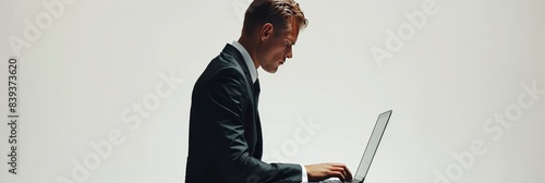 Professional man in formal attire typing on laptop in minimalistic and realistic image on plain white background, occupying one-third of space, Created with Generative AI. photo