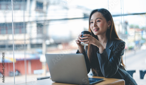 Smiling young asian businesswoman using computer at home office workplace, happy korean employee working on laptop, attractive japanese or chinese woman student studying communicating online with pc