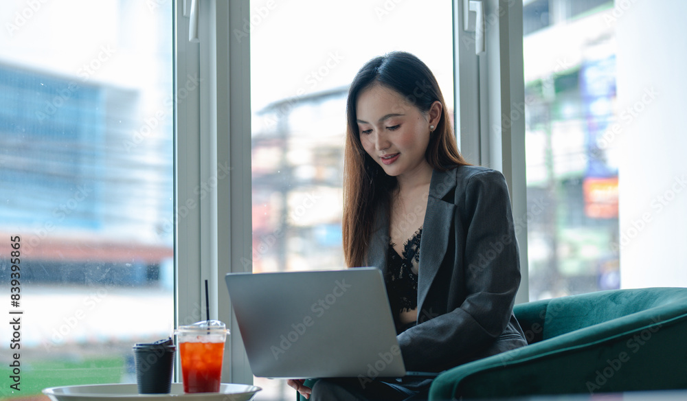 Smiling young asian businesswoman using computer at home office workplace, happy korean employee working on laptop, attractive japanese or chinese woman student studying communicating online with pc Smiling young asian businesswoman using computer at home office workplace, happy korean employee working on laptop, attractive japanese or chinese woman student studying communicating online with pc