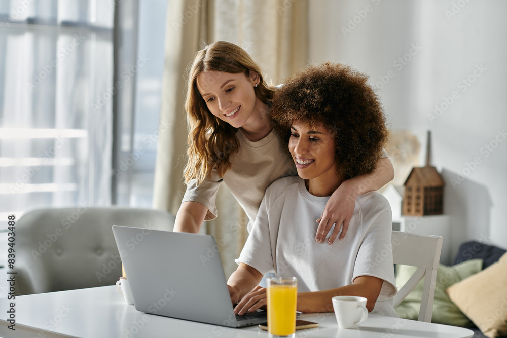 A diverse lesbian couple relaxes at home, enjoying a morning together. A diverse lesbian couple relaxes at home, enjoying a morning together.