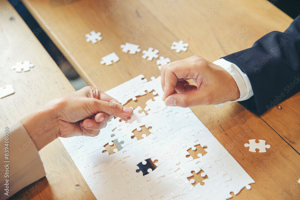 Strategy Planning and Solution Business Concept. Group of Business people holding piece of jigsaw puzzle to solution problem on wooden desk. Professional Businessman and Partnership meeting in office. Strategy Planning and Solution Business Concept. Group of Business people holding piece of jigsaw puzzle to solution problem on wooden desk. Professional Businessman and Partnership meeting in office.