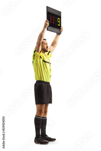 Photography Side shot of a football referee holding a substitute board