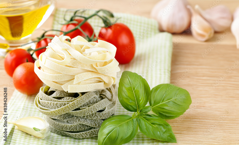 raw pasta with basil on wooden table raw pasta with basil on wooden table