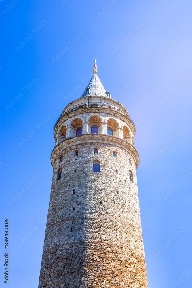 The Galata Tower in Istanbul, Turkey, stands tall and prominent against a clear blue sky. The Galata Tower in Istanbul, Turkey, stands tall and prominent against a clear blue sky.