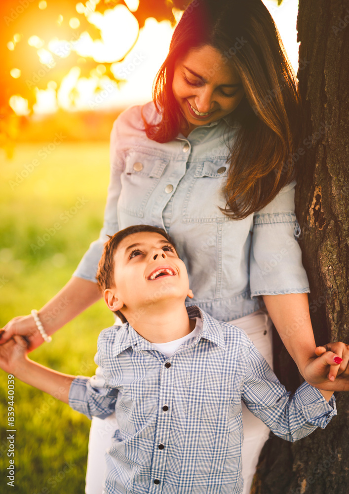 Obraz premium Beautiful mother with son on sunset field