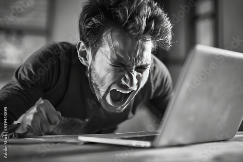 a man angry at a laptop screen, rage , frustrated , stress, mad , furious

