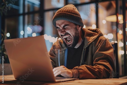 a man angry at a laptop screen, rage , frustrated , stress, mad , furious