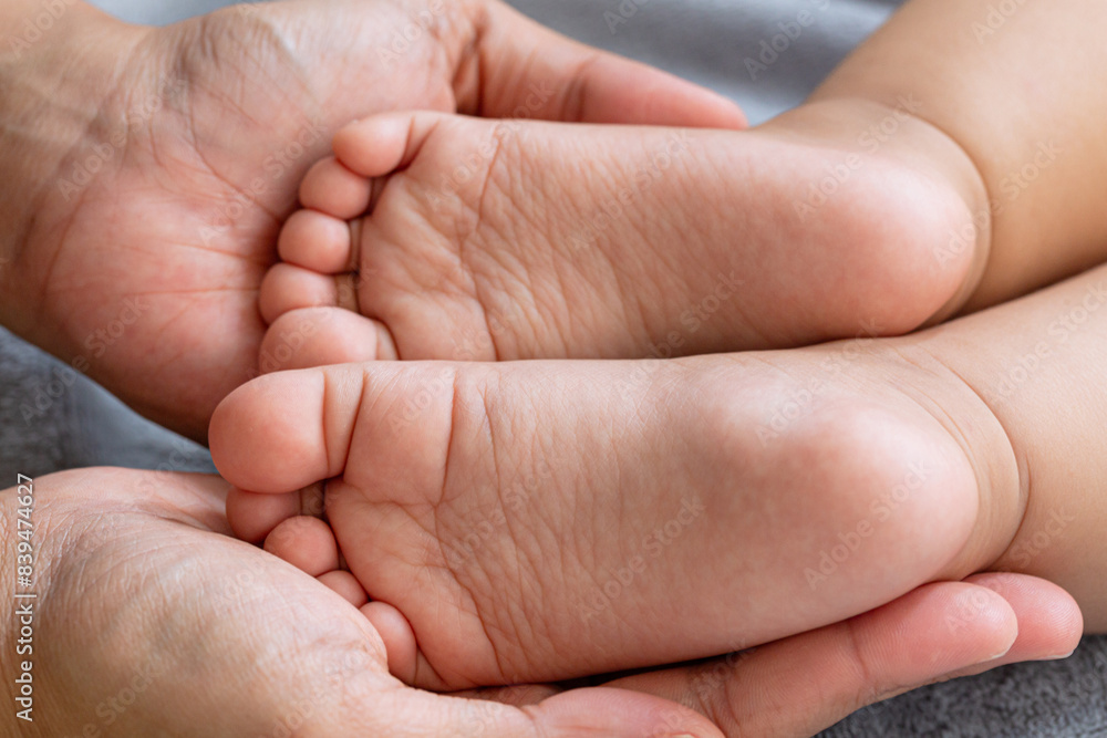 Children's soles,Mother massaging her child's foot, shallow focus Children's soles,Mother massaging her child's foot, shallow focus