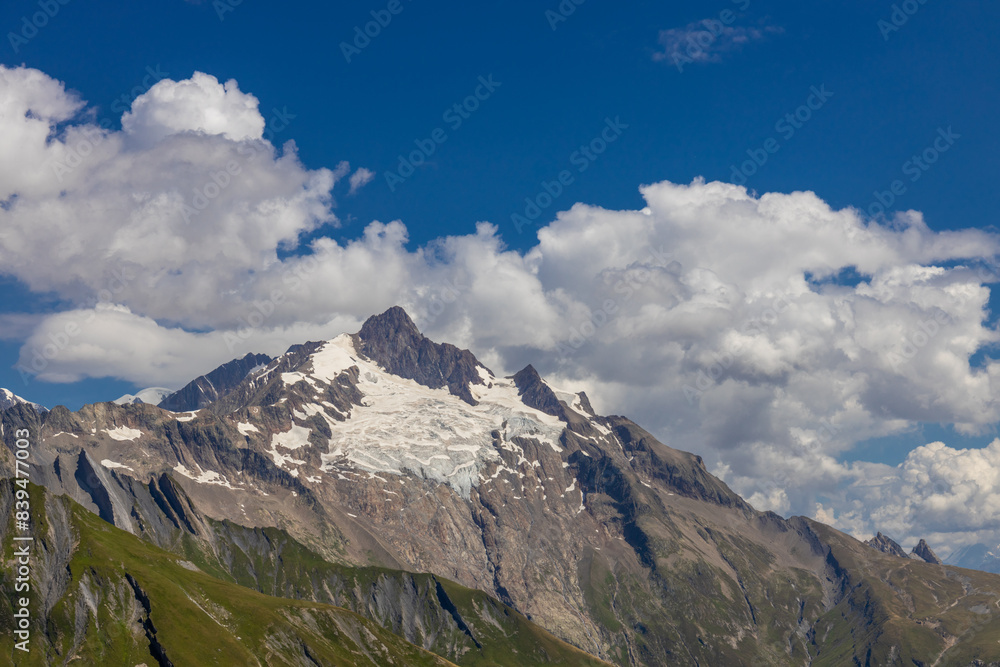 Tour du Montblanc beautiful mountain ladscapes of the Alps green valley, snow summit of Montblanc and rocky peaks of Aiguille du Midi in summer sunny weather blue sky, trekking and hiking in Chamonix Tour du Montblanc beautiful mountain ladscapes of the Alps green valley, snow summit of Montblanc and rocky peaks of Aiguille du Midi in summer sunny weather blue sky, trekking and hiking in Chamonix