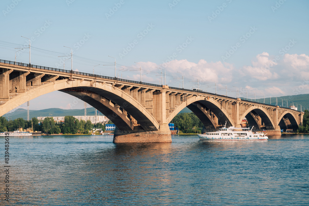 Communal bridge over the Yenisei River at beauty sunny summer day in Krasnoyarsk city. Communal bridge over the Yenisei River at beauty sunny summer day in Krasnoyarsk city.