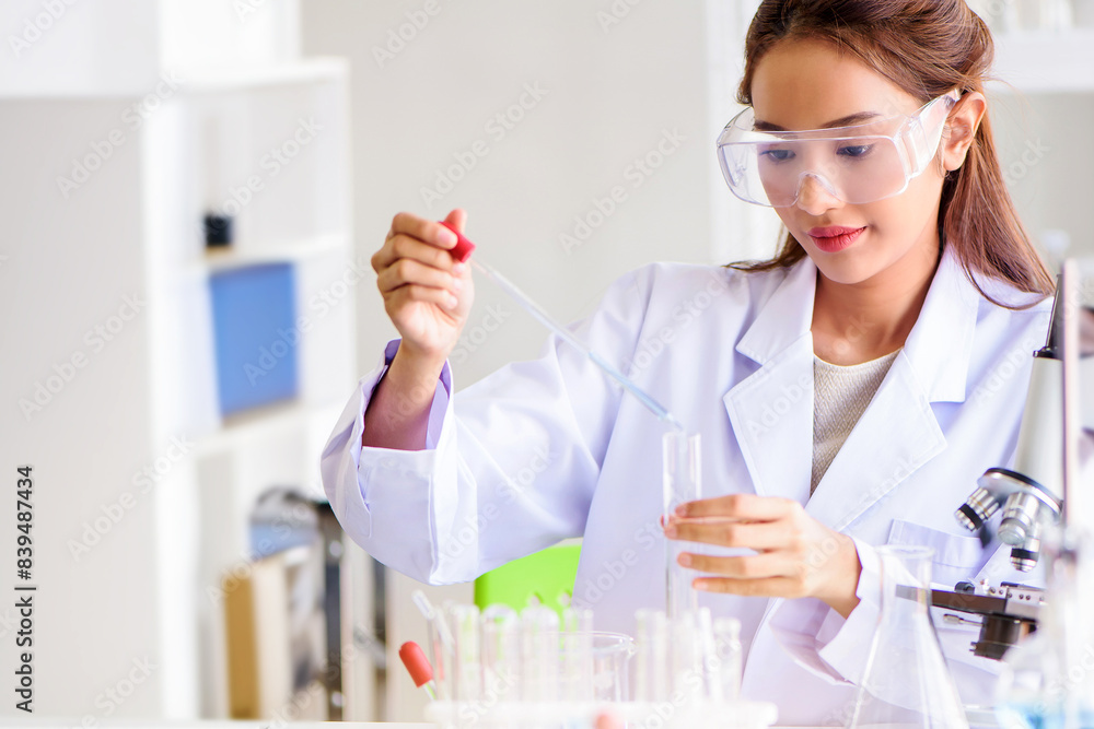 Attractive scientist woman testing chemical sample in flask at laboratory with lab glassware background. Science or chemistry research and development concept. Attractive scientist woman testing chemical sample in flask at laboratory with lab glassware background. Science or chemistry research and development concept.