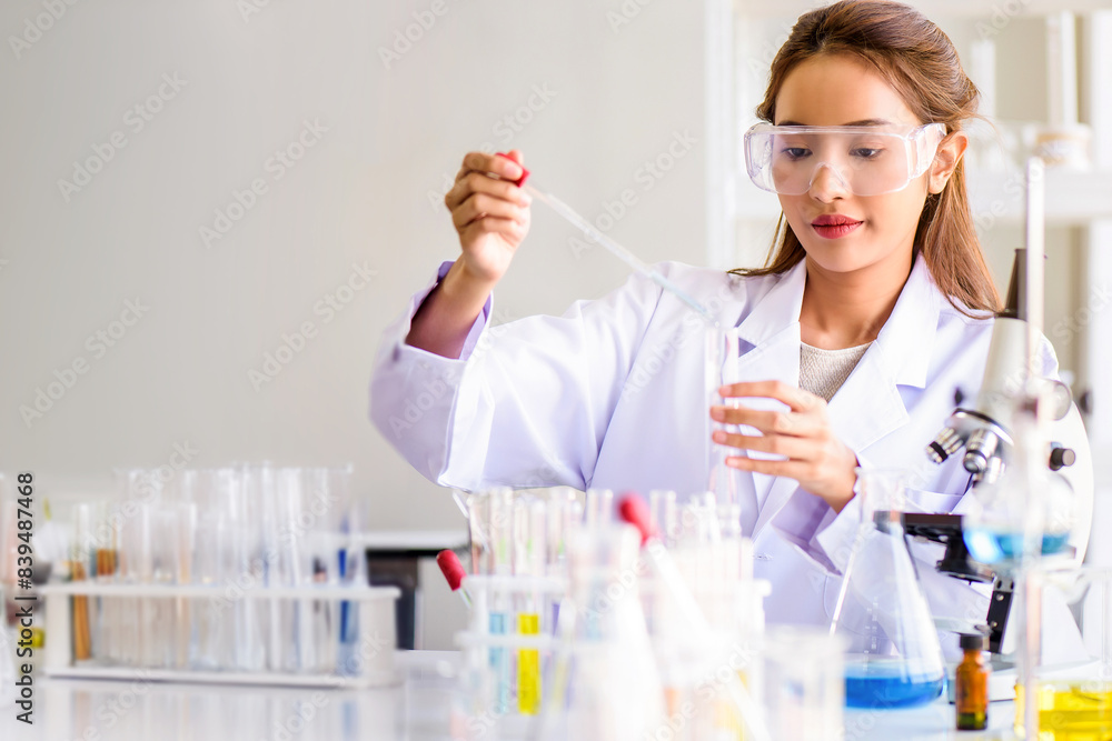 Attractive scientist woman testing chemical sample in flask at laboratory with lab glassware background. Science or chemistry research and development concept. Attractive scientist woman testing chemical sample in flask at laboratory with lab glassware background. Science or chemistry research and development concept.