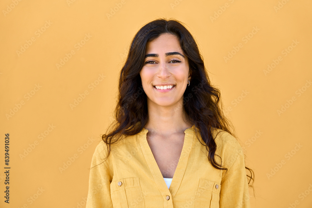 Headshot closeup face portrait of middle eastern Israel girl student isolated on yellow colourful background. Smiling young Arabian Indian woman, businesswoman, business freelancer looking at camera Headshot closeup face portrait of middle eastern Israel girl student isolated on yellow colourful background. Smiling young Arabian Indian woman, businesswoman, business freelancer looking at camera