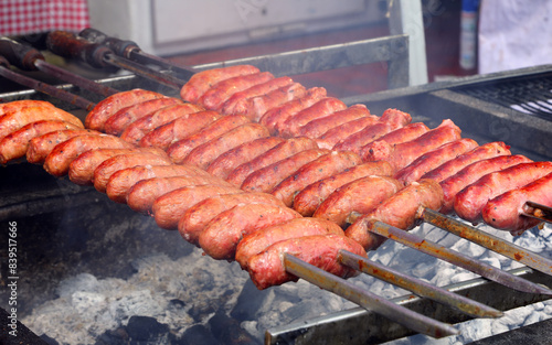 plethora of pork sausages skewered and roasted in a restaurant bbq