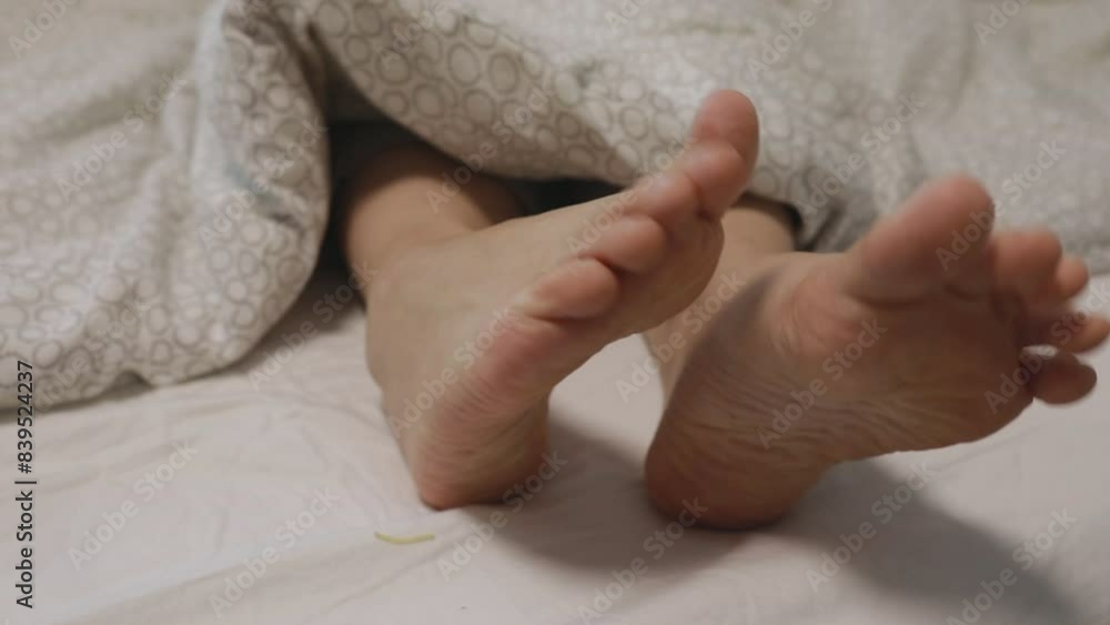 Relaxing Sunday Morning With Bare Feet Sticking Out Under Cozy Bedroom Duvet Relaxing Sunday Morning With Bare Feet Sticking Out Under Cozy Bedroom Duvet
