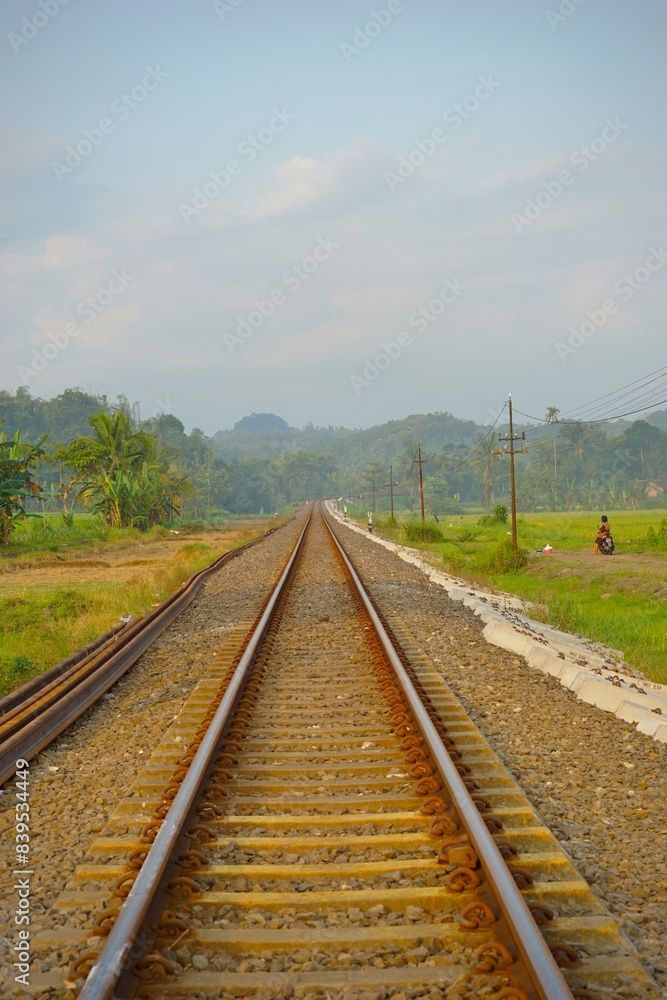 Fototapeta premium Railway tracks in rice fields. Beautiful views of rural Indonesia