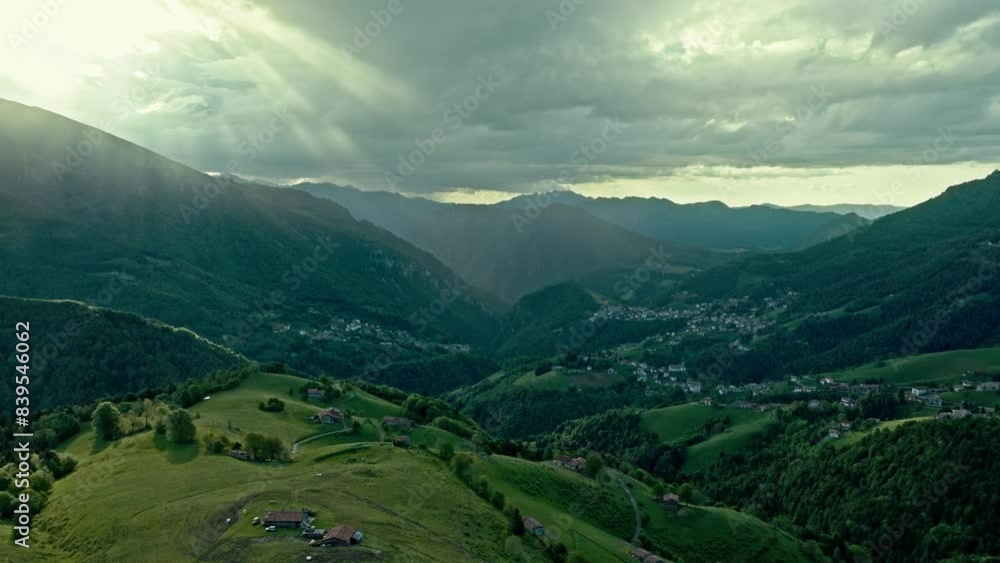 view of mountain landscape with sun beams through the clouds, aerial footage view of mountain landscape with sun beams through the clouds, aerial footage
