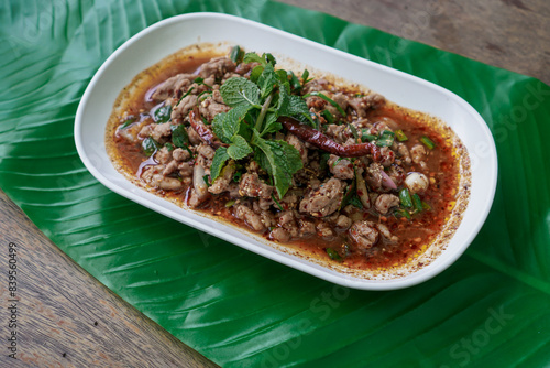 Larb Ped, Laab Ped, famous North East Thai food, spicy minced duck salad served with chilli, slice cucumber and mint leaves, Thai street food, Esarn, E-Sarn, Esan, E-san, Isan, Isaan, Issarn, Issan.