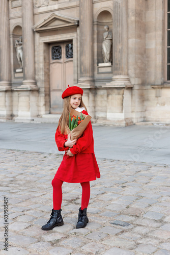 A girl in a red beret in Paris. Children's fashion. Style. Tulips