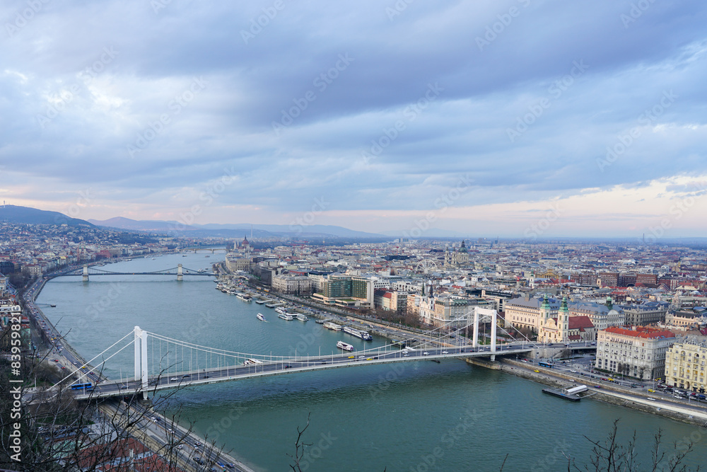 Fototapeta premium Beautiful view of the city of Budapest with Danube river with bridges from Gellert Hill cloudy sky