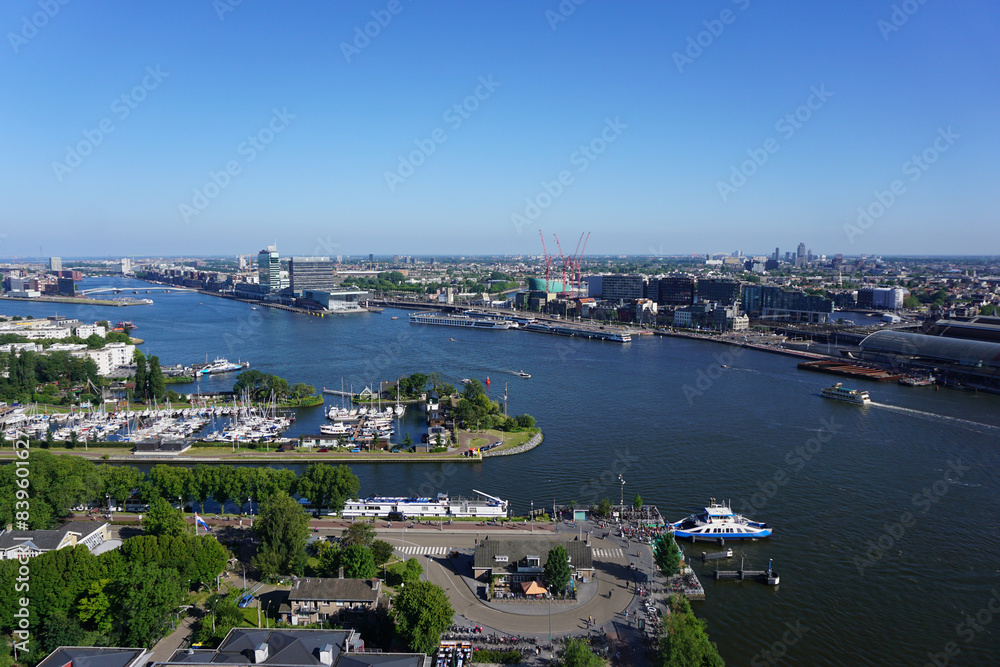 High angle view of river and buildings against clear blue sky