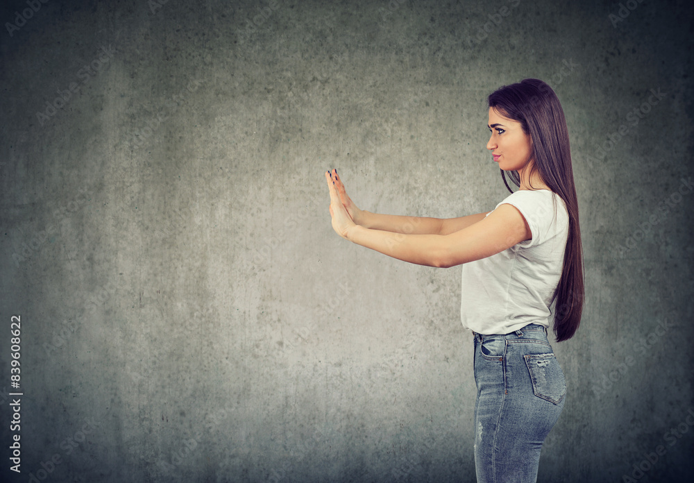 woman pushing with hands an invisible obstacle woman pushing with hands an invisible obstacle