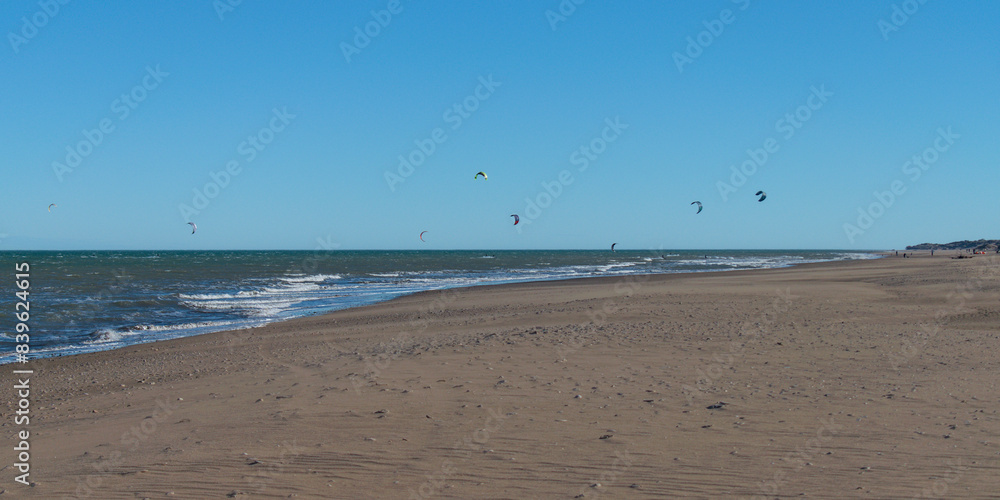 kitesurfing at the seashore on a windy afternoon kitesurfing at the seashore on a windy afternoon