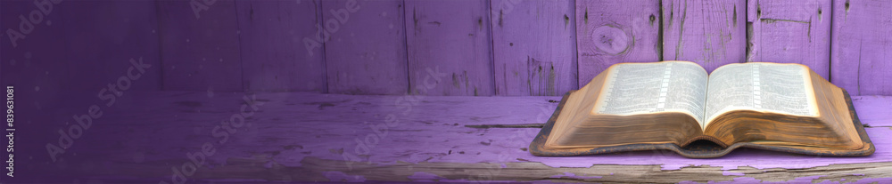 Fototapeta premium Open holy bible on a purple wooden surface. With extra wide copy space to add text. Holy scriptures. Ideal for blogs, presentations, religious meetings, Prayer groups and much more. Panoramic banner.