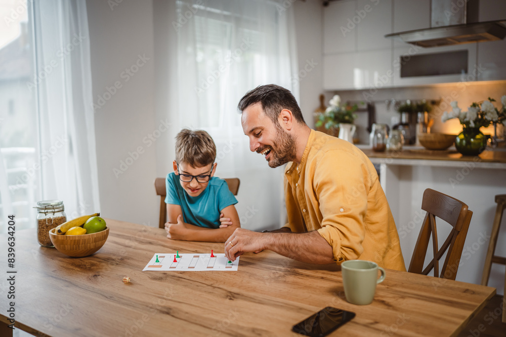 Father and son play board game have fun together at home Father and son play board game have fun together at home