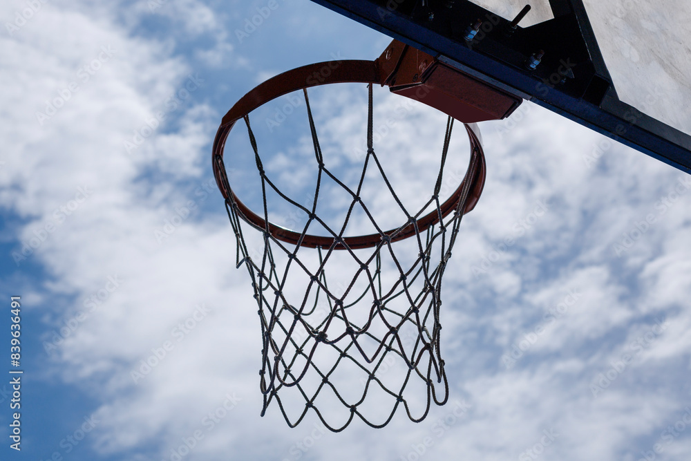 Basketball hoop against cloudy sky on a sunny day Basketball hoop against cloudy sky on a sunny day