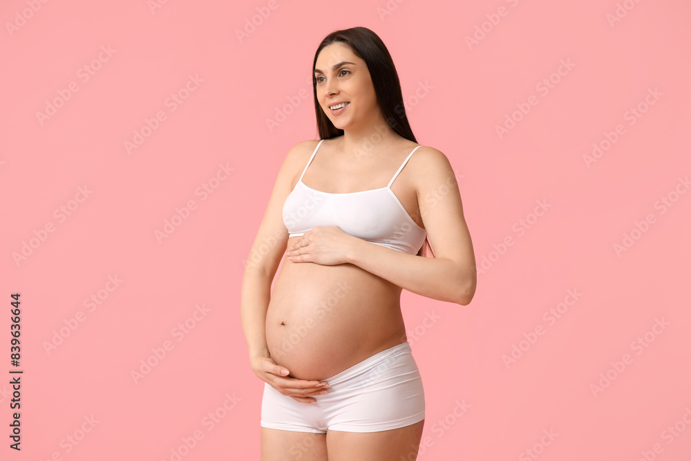 Young pregnant woman in underwear on pink background Young pregnant woman in underwear on pink background
