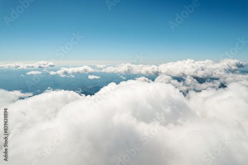 Aerial view of beautiful nature white clouds, blue sky horizon shooting from a drone on a sunny day high in the atmosphere front view