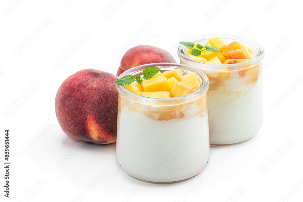Homemade yogurt in a jar with fresh peach fruit isolated on white Homemade yogurt in a jar with fresh peach fruit isolated on white