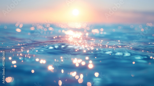 A close-up view of the ocean surface, capturing the subtle ripples and shimmering light reflecting from the setting sun