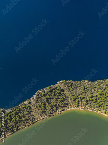 Drone aerial view of narrow land with forest between sea and lake in Dugi Otok island, Telascica National Park, Croatia photo