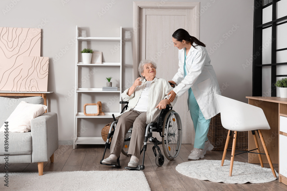 Senior woman in wheelchair with physical therapist at home Senior woman in wheelchair with physical therapist at home