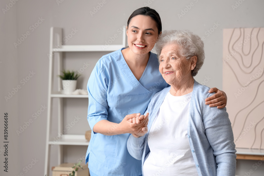 Senior woman with physical therapist hugging at home Senior woman with physical therapist hugging at home