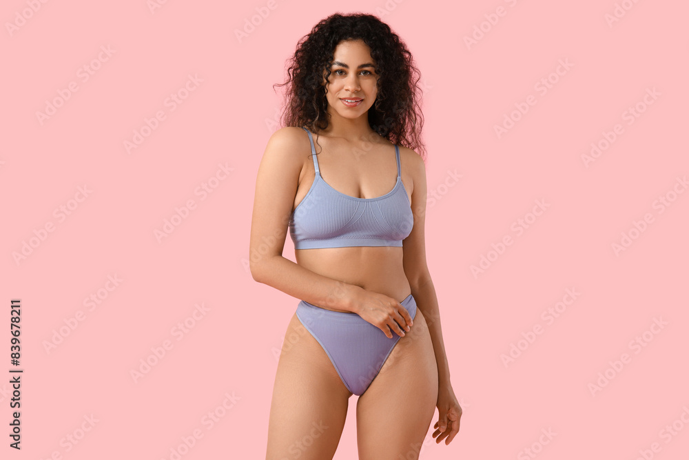 Beautiful young happy African-American woman in stylish underwear on pink background Beautiful young happy African-American woman in stylish underwear on pink background