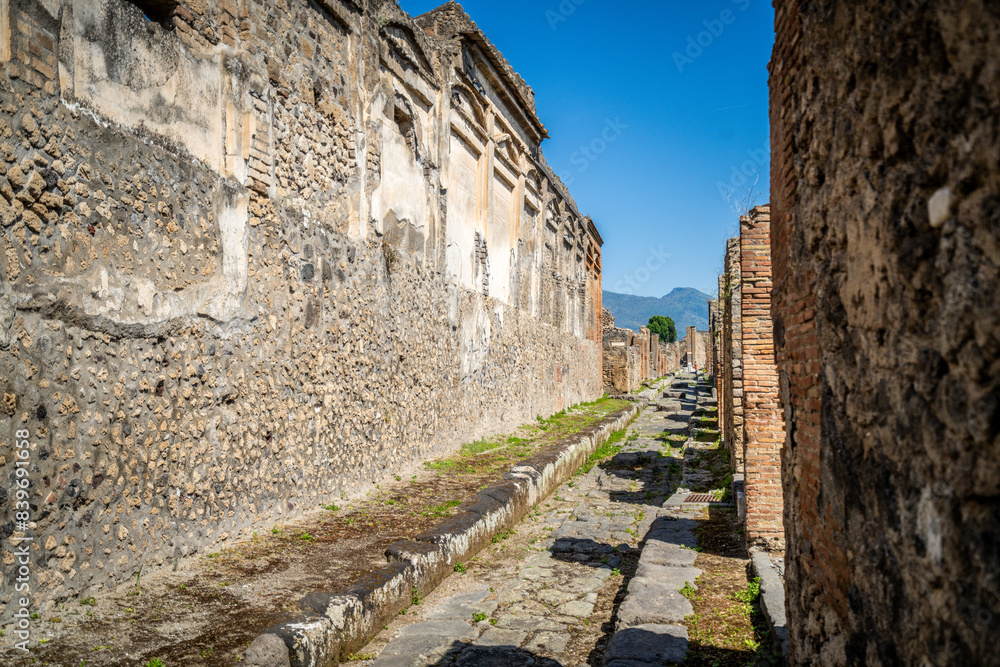 Ruins of ancient city of Pompeii, ancient roman city against Vesuvius volcano at sunset, Italy Ruins of ancient city of Pompeii, ancient roman city against Vesuvius volcano at sunset, Italy
