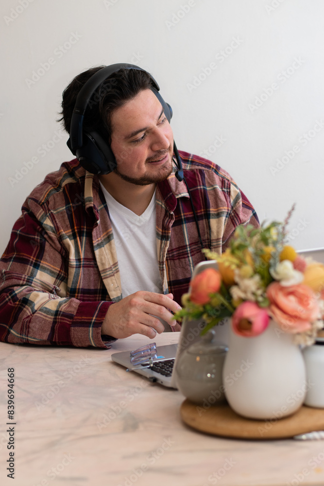 Happier man looking to the horizon while are using his laptot in the living room Happier man looking to the horizon while are using his laptot in the living room