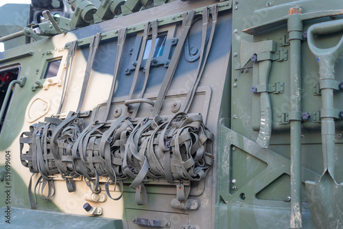 The armored side of the camouflaged modern 4x4 MRAP armored fighting vehicle photo