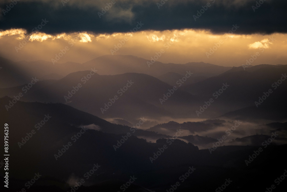 Sun rays rising over mountain Sun rays rising over mountain